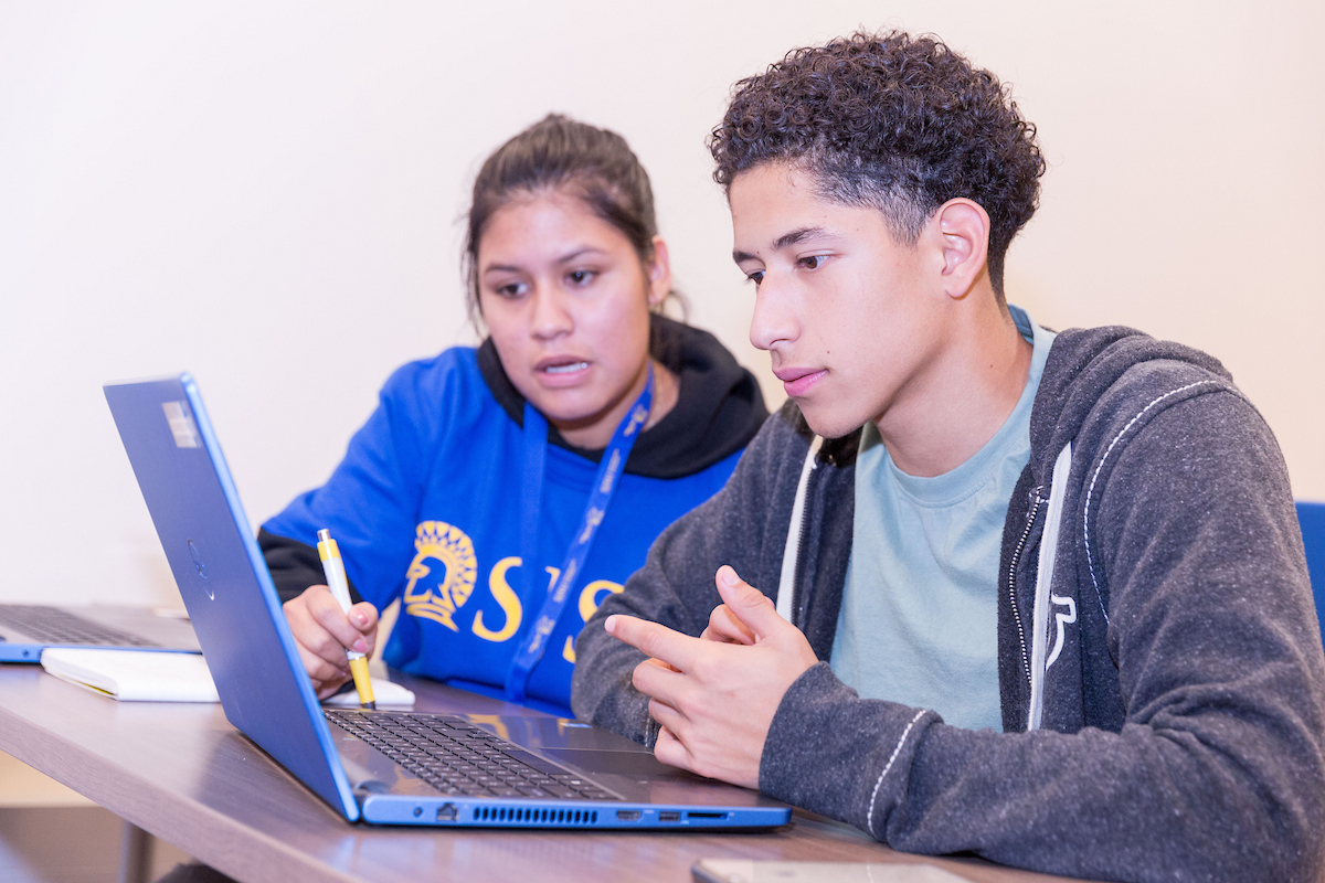 student and counselor on laptop