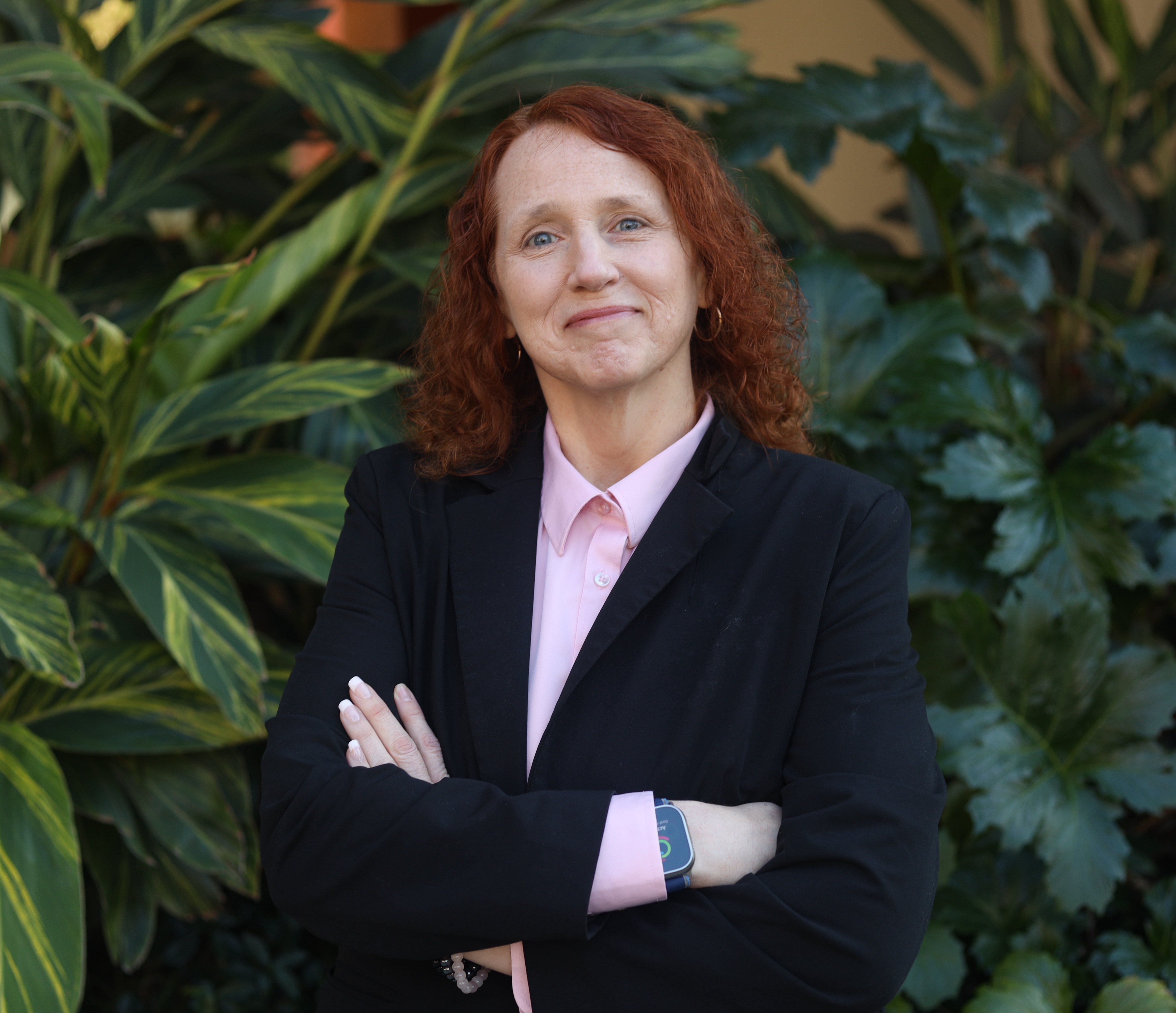 Headshot of interim dean and TED faculty david whitenack with green leaves in background
