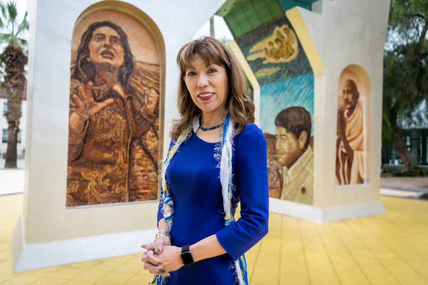 Dr. Cynthia Teniente-Matson posing in front of the Cesar Chavez monument.