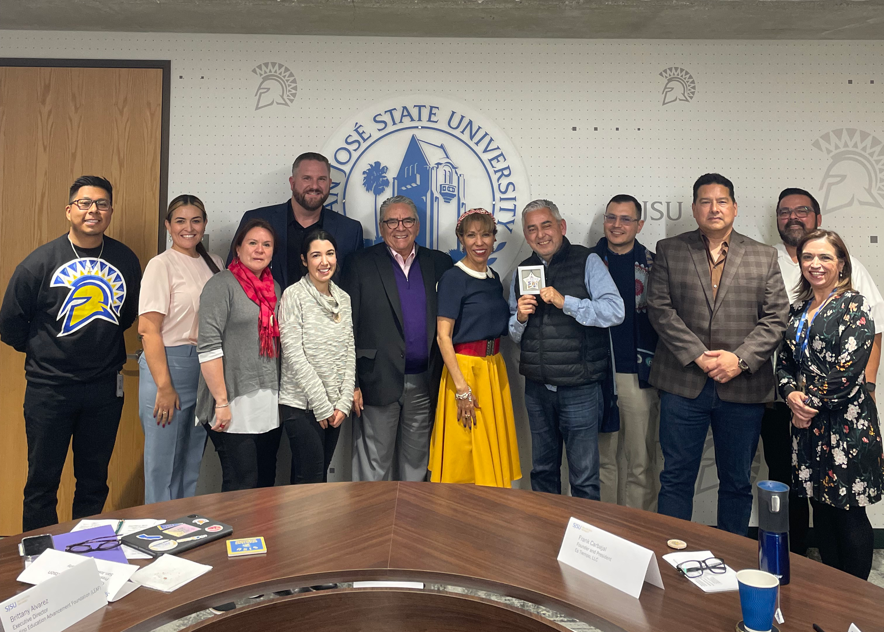 Group photo of the Latino advisory council in the president's conference room