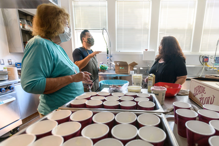 Recovery cafe volunteers prepping coffee in the kitchen.